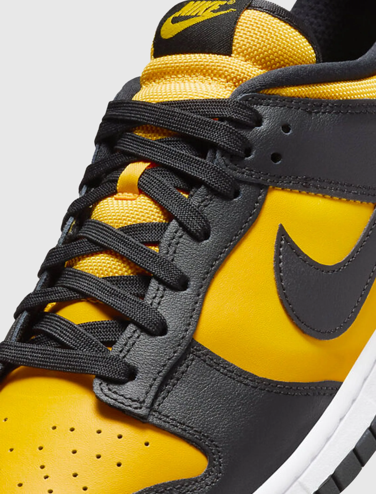 Dunk Low Black University Gold sneaker.