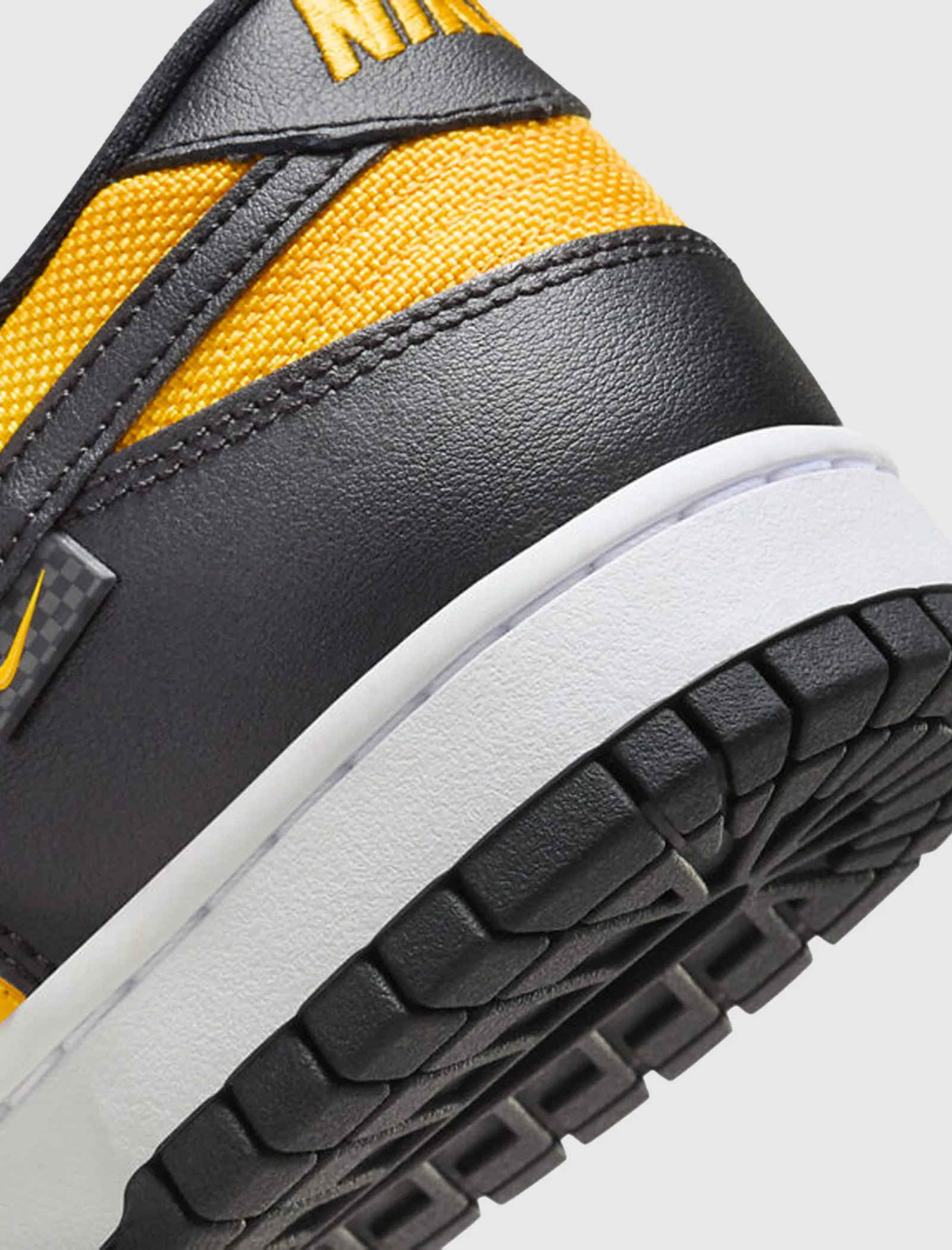 Dunk Low Black University Gold sneaker.