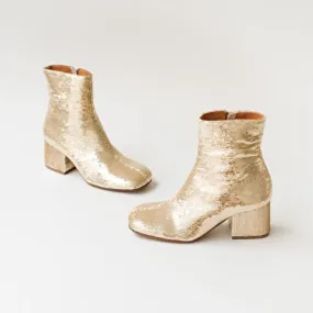 Heeled boots in platinum sequins