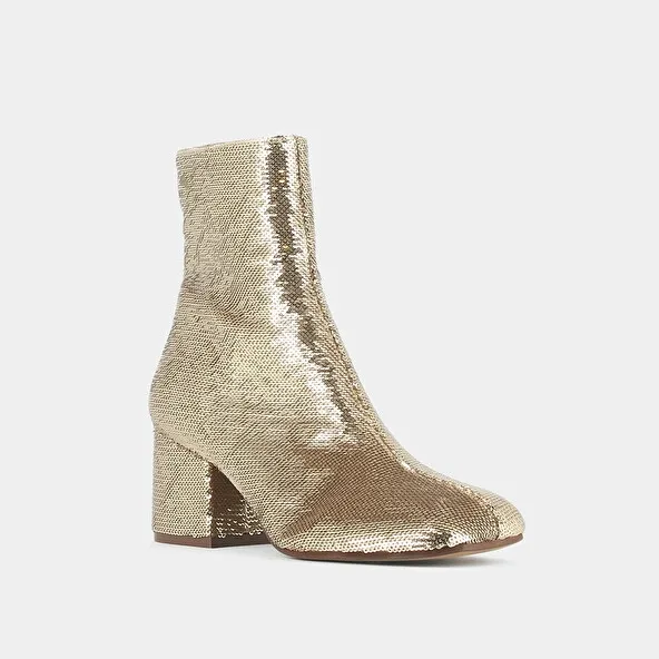 Heeled boots in platinum sequins