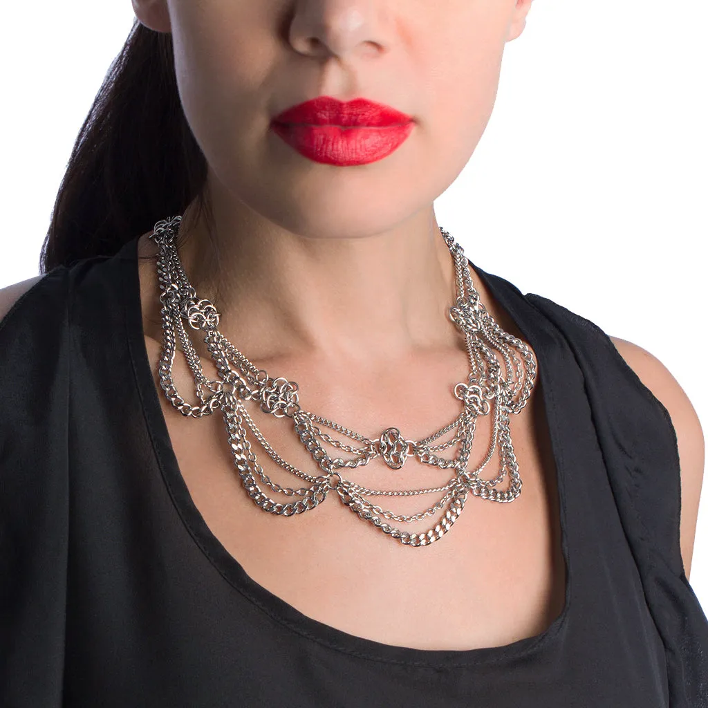 Metal 2-tier chain necklace with draping chains and rosettes