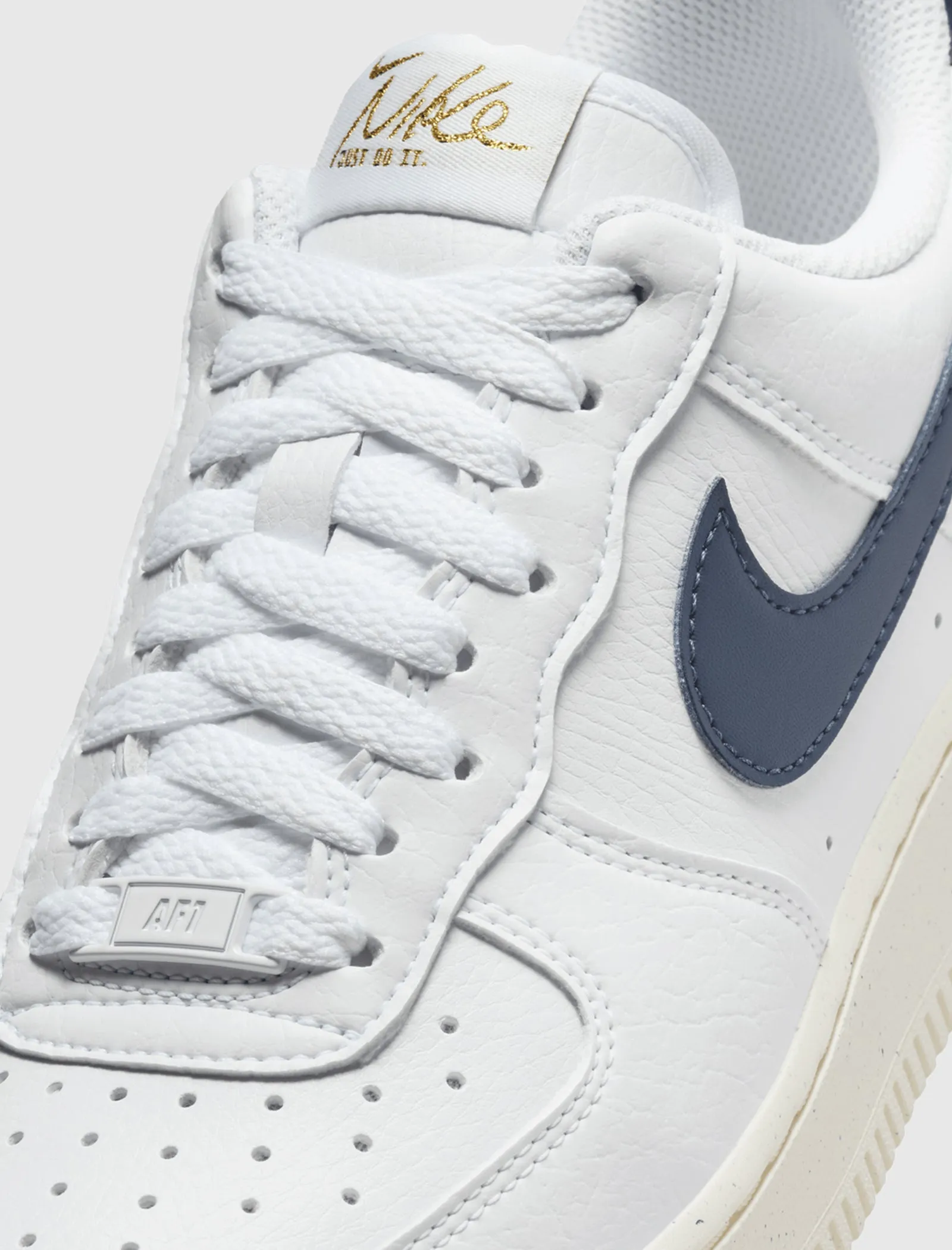 The result is: Nike Women's Air Force 1 '07 Next Nature White/Obsidian/Metallic Gold sneakers