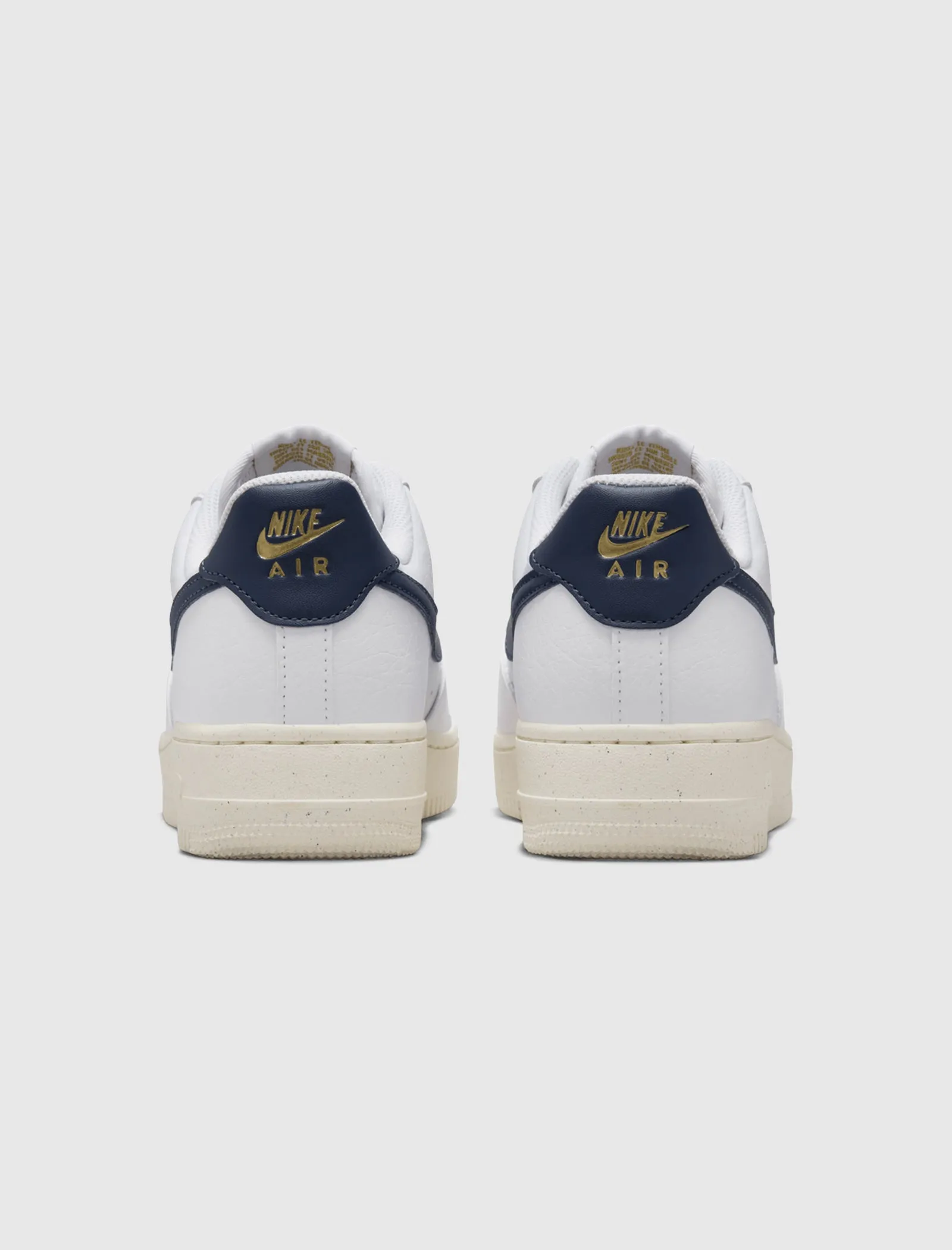 The result is: Nike Women's Air Force 1 '07 Next Nature White/Obsidian/Metallic Gold sneakers